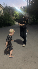 Kids dancing outdoors at dusk in Karaganda, Kazakhstan