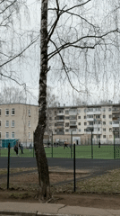 Young person in pink jacket walks through Chaikovsky, Russia