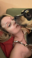 Woman rests with dog on couch in Tel Aviv