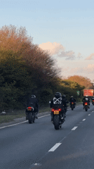 Motorcyclists ride in formation on highway near Orsett