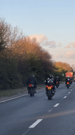 Motorcyclists ride in formation on highway near Orsett