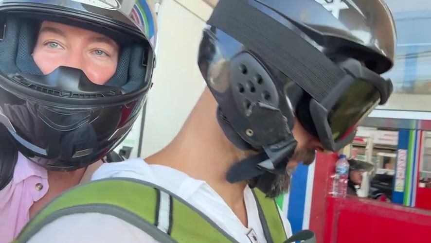 Helmeted riders pause at a Kuta Selatan gas station