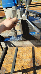 Worker operates magnetic drill press on wood in Burgas