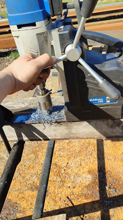 Worker operates magnetic drill press on wood in Burgas