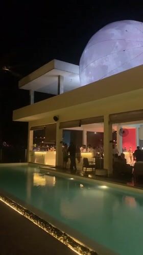 Evening gathering at moonlit restaurant venue in Midigama