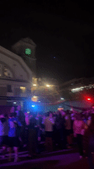 Berlin crowd watches soccer match in neon-lit indoor venue