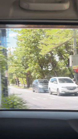Two people spotted on scooter in Kuta street scene