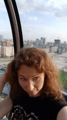 Visitors enjoy glass observation ride in Yekaterinburg on sunny afternoon