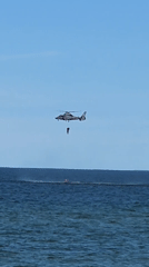 Helicopter hoist operation over Baltic Sea, Palanga streets below