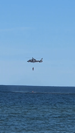 Helicopter hoist operation over Baltic Sea, Palanga streets below