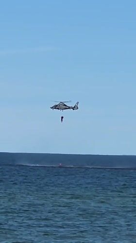 Helicopter hoist operation over Baltic Sea, Palanga streets below