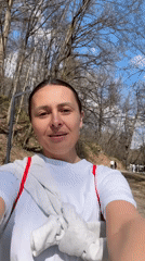 Woman documents park visit, films duck at pond in Russia