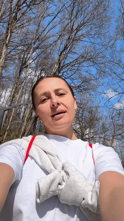 Woman documents park visit, films duck at pond in Russia