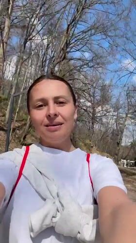 Woman documents park visit, films duck at pond in Russia