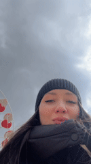 Woman films herself near Ferris wheel in Cheboksary