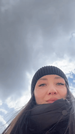 Woman films herself near Ferris wheel in Cheboksary