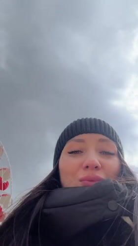 Woman films herself near Ferris wheel in Cheboksary