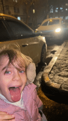 Woman and child play in snow on Moscow street