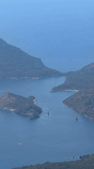 Aerial footage captures Fethiye's scenic coastline with boats, paraglider