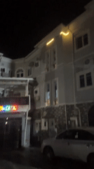 Night scene captured in Asaba shows lit building, vehicle