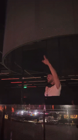 DJ performs at illuminated nightclub booth in Sofia