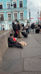 Street musician performs near Kazan Cathedral in Saint Petersburg