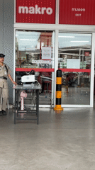 Security guards monitor Makro store entrance in Wichit, Thailand
