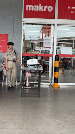 Security guards monitor Makro store entrance in Wichit, Thailand