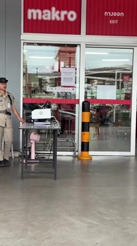 Security guards monitor Makro store entrance in Wichit, Thailand