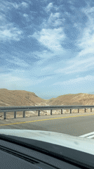 Vehicle passenger records Dead Sea landscape view from road