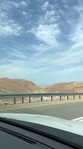 Vehicle passenger records Dead Sea landscape view from road