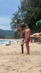 Beach hangout with staff practice, selfies, and boats on calm water
