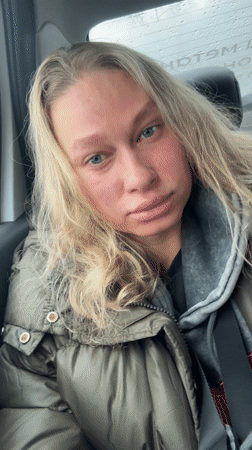 Tired woman in green jacket observed in rainy Perm