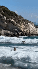 Rough surf rolls into the rocky shores of Toroni, Greece