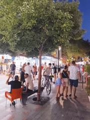 Evening foot traffic along a shop-lined street in Kuşadası
