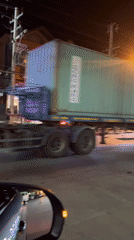 Container truck observed passing vehicles at night in Thailand