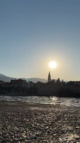 Sunset beach acrobatics in front of Budva's old town