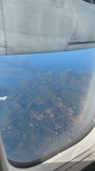 Passenger films aerial view of Philippine mountains from airplane