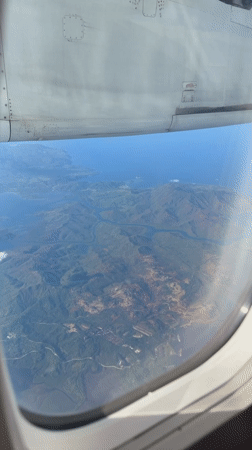 Passenger films aerial view of Philippine mountains from airplane