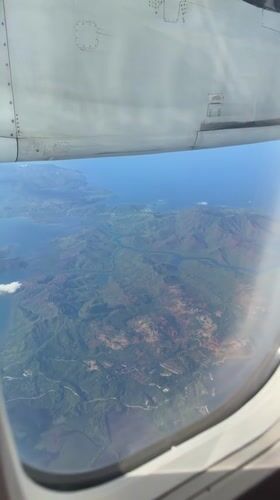 Passenger films aerial view of Philippine mountains from airplane