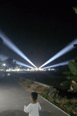 Nighttime gathering on a lit road in Ngemplik Wetan