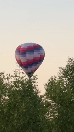 Hot air balloons launch at dusk outside Dmitrov