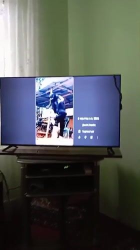 Person watches social media videos on TV in Chirchik