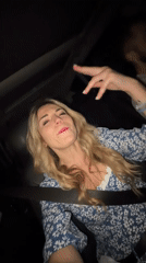 Woman sings enthusiastically in passenger seat, Drobnići Montenegro