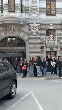 Tourists photograph Art Nouveau architecture in Riga
