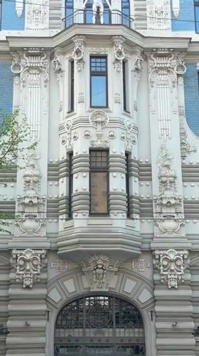 Tourists photograph Art Nouveau architecture in Riga