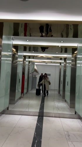 Woman with flowers travels through modern Batumi buildings