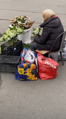 Flower vendor, bronze children sculpture observed near Petersburg metro