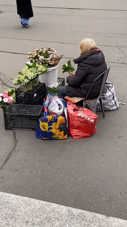 Flower vendor, bronze children sculpture observed near Petersburg metro