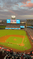 Angel Stadium baseball game under a pink sunset sky